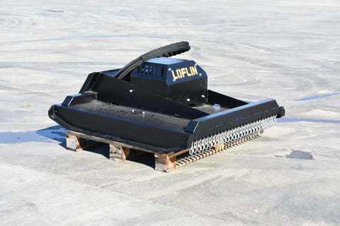 Mini skid steer brush cutter clearing overgrowth
